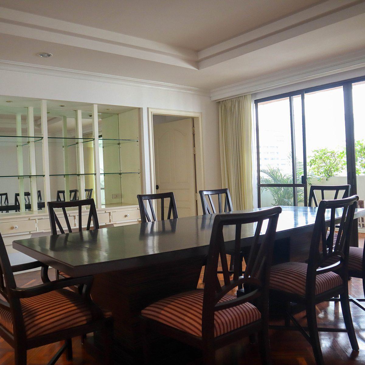 Hawaii Tower — the dining room of a unit, dark wood table and chairs