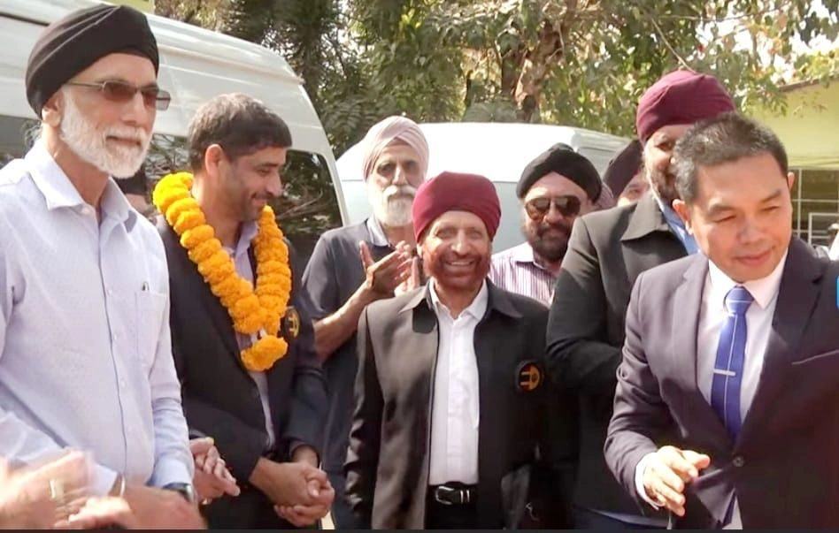 A garlanded welcome for the delegation on handover day